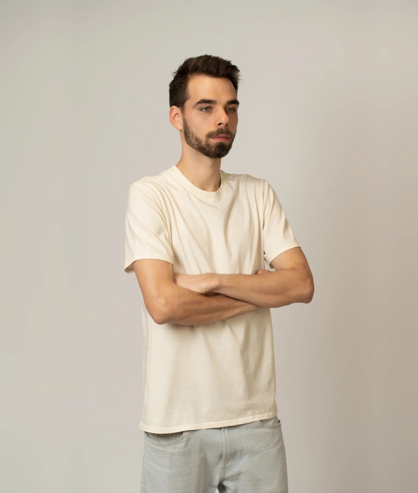 Male model wearing size M unbleached, undyed organic cotton T-shirt.