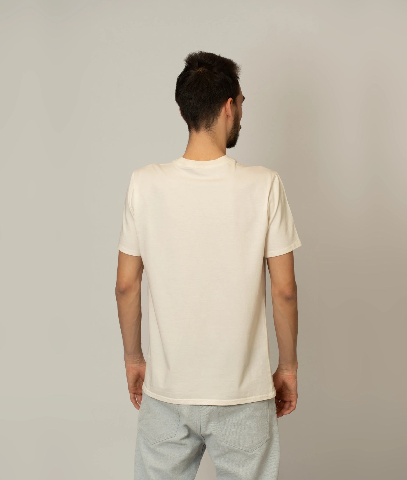 Back view of male model in size M soft, sustainable organic cotton T-shirt.