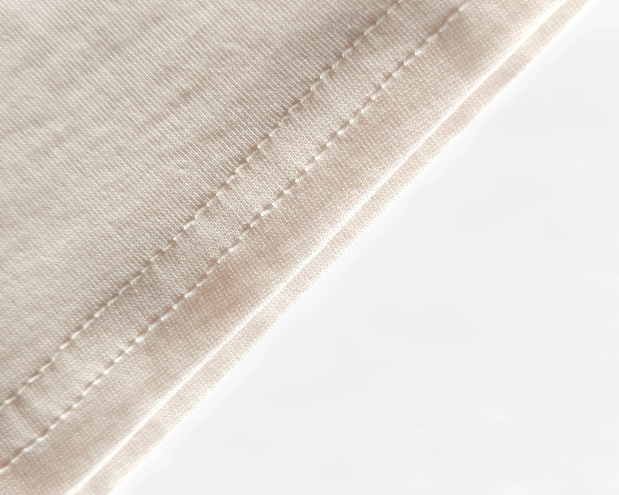 Close-up of 100% organic cotton thread, showing natural texture and fibers.