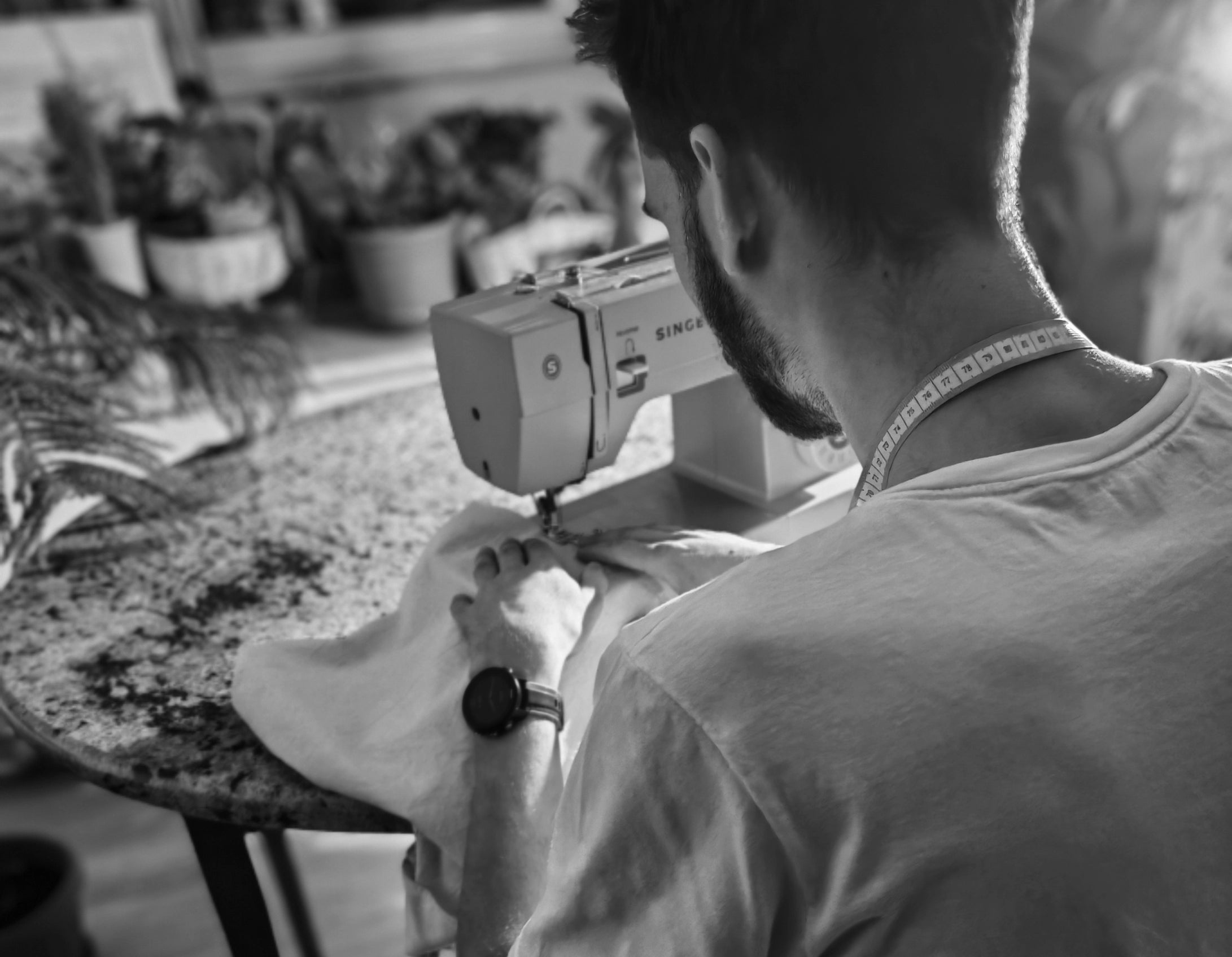 The founder of pamantean with a sewing machine in a living room.